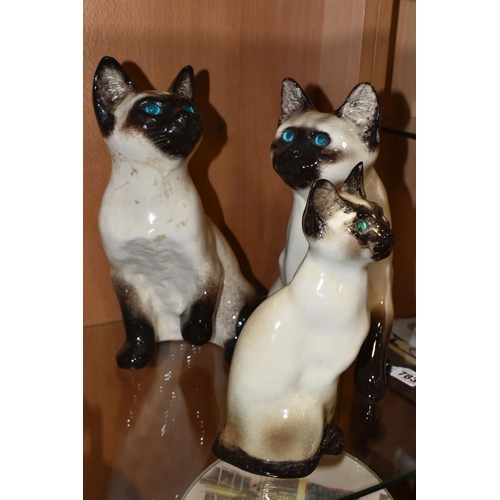 783 - THREE WINSTANLEY POTTERY SIAMESE CATS, comprising a seated cat T34, height 23cm (chipped left ear, a... 