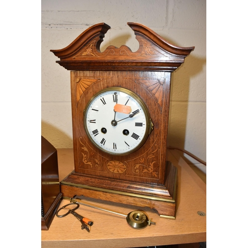 787 - A GROUP OF FOUR EARLY 20TH CENTURY CLOCKS, comprising a bracket clock, gong striking with a printed ... 