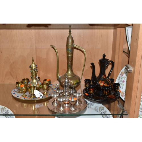 818 - THREE DECORATIVE ARABIC COFFEE SETS AND AN ORNAMENTAL DALLAH comprising an Anglo-Indian brass dallah... 