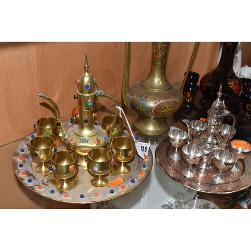 818 - THREE DECORATIVE ARABIC COFFEE SETS AND AN ORNAMENTAL DALLAH comprising an Anglo-Indian brass dallah... 