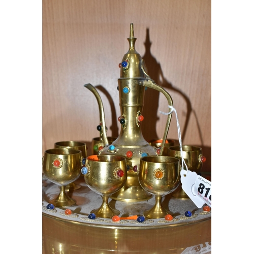 818 - THREE DECORATIVE ARABIC COFFEE SETS AND AN ORNAMENTAL DALLAH comprising an Anglo-Indian brass dallah... 