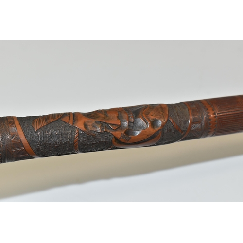 831 - A JAPANESE MEIJI PERIOD SAMURAI CARVED BAMBOO WALKING STICK carved in relief with five carved faces ... 