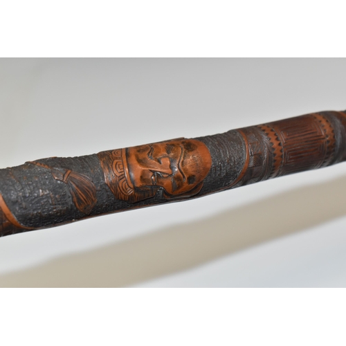 831 - A JAPANESE MEIJI PERIOD SAMURAI CARVED BAMBOO WALKING STICK carved in relief with five carved faces ... 