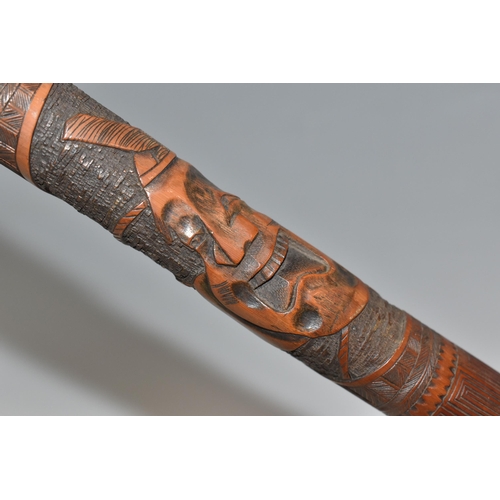 831 - A JAPANESE MEIJI PERIOD SAMURAI CARVED BAMBOO WALKING STICK carved in relief with five carved faces ... 