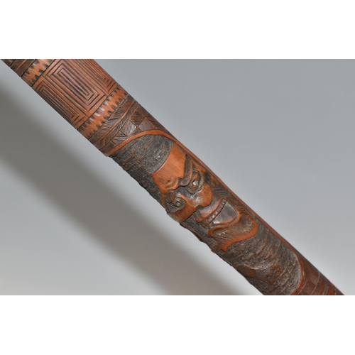 831 - A JAPANESE MEIJI PERIOD SAMURAI CARVED BAMBOO WALKING STICK carved in relief with five carved faces ... 