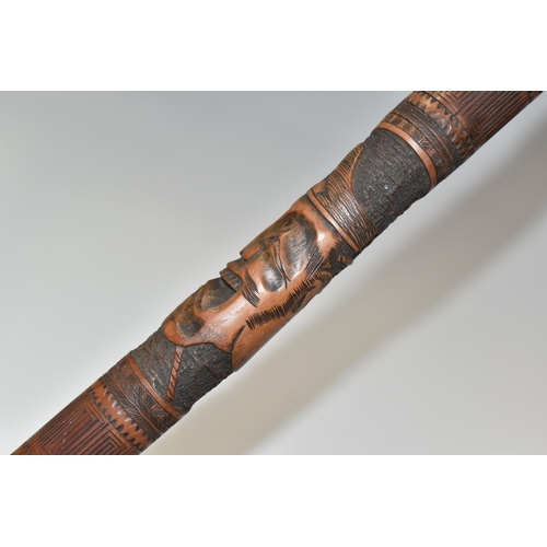 831 - A JAPANESE MEIJI PERIOD SAMURAI CARVED BAMBOO WALKING STICK carved in relief with five carved faces ... 