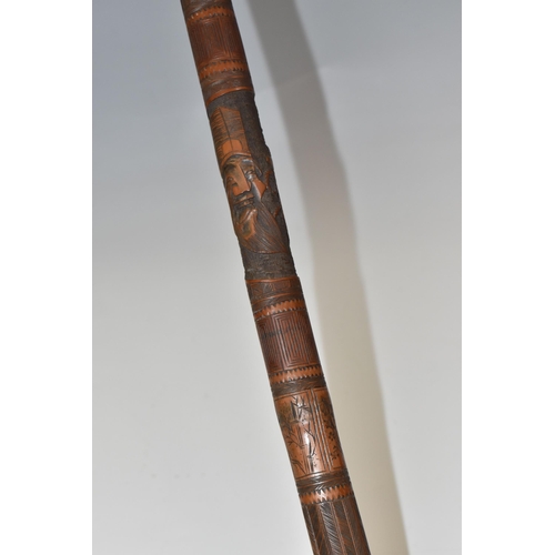 831 - A JAPANESE MEIJI PERIOD SAMURAI CARVED BAMBOO WALKING STICK carved in relief with five carved faces ... 