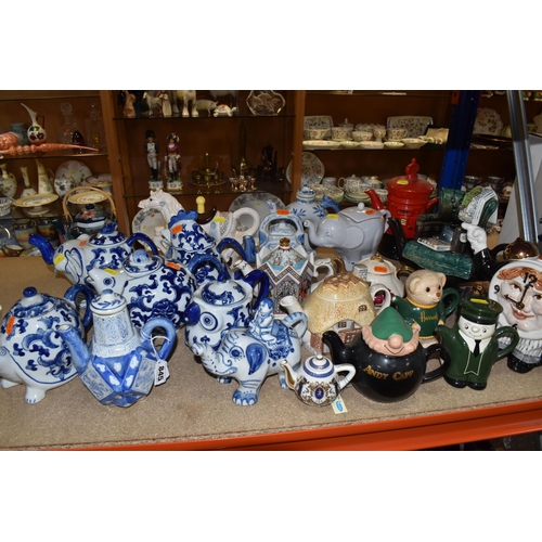 845 - A COLLECTION OF TWENTY-THREE NOVELTY TEAPOTS to include six blue and white animal-shaped teapots com... 