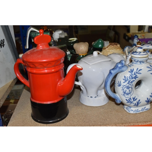 845 - A COLLECTION OF TWENTY-THREE NOVELTY TEAPOTS to include six blue and white animal-shaped teapots com... 