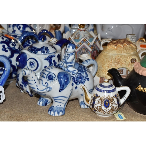 845 - A COLLECTION OF TWENTY-THREE NOVELTY TEAPOTS to include six blue and white animal-shaped teapots com... 