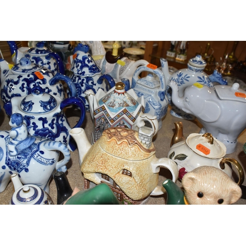 845 - A COLLECTION OF TWENTY-THREE NOVELTY TEAPOTS to include six blue and white animal-shaped teapots com... 