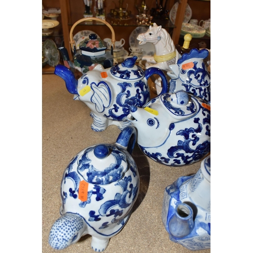 845 - A COLLECTION OF TWENTY-THREE NOVELTY TEAPOTS to include six blue and white animal-shaped teapots com... 