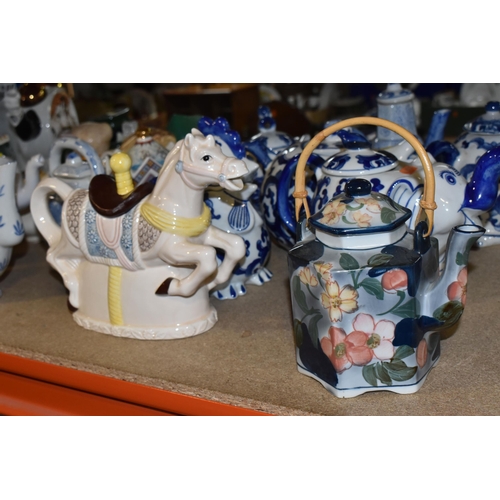 845 - A COLLECTION OF TWENTY-THREE NOVELTY TEAPOTS to include six blue and white animal-shaped teapots com... 