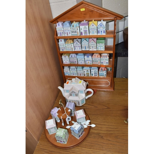 861 - A 'BROOKS AND BENTLEY' SPICE RACK, TEA POT, AND CONDIMENT SERVING TRAY comprising a wooden wall-moun... 