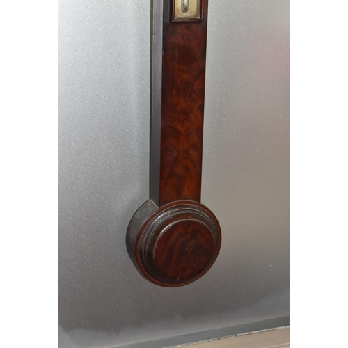 822 - A GEORGIAN CISTERN BAROMETER, in flame cut mahogany, the arched glass door enclosing a face signed '... 