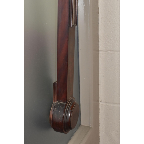 822 - A GEORGIAN CISTERN BAROMETER, in flame cut mahogany, the arched glass door enclosing a face signed '... 