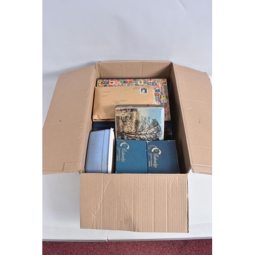 183 - BOX WITH FOUR ALBUMS OF WORLDWIDE STAMPS AND LOOSE IN PACKETS