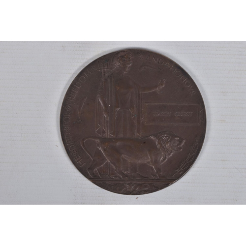 210 - A WWI CASUALTY PAIR OF MEDALS AND MEMORIAL PLAQUE, the medals are named to 102477 Private H Guest M.... 