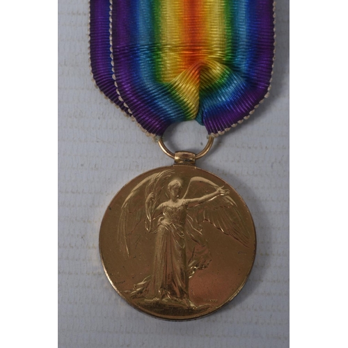 210 - A WWI CASUALTY PAIR OF MEDALS AND MEMORIAL PLAQUE, the medals are named to 102477 Private H Guest M.... 