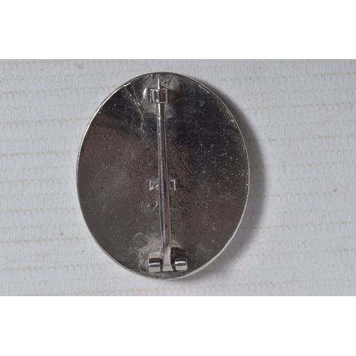 228 - A GERMAN SILVER WOUND BADGE WITH MAKER MARK L21, it has a vertical pin and the award has a solid bac... 