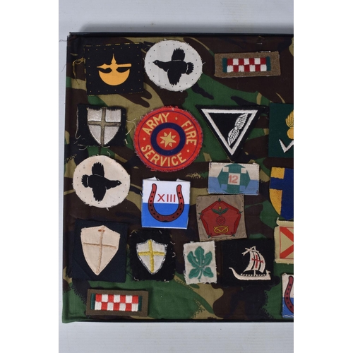 266 - RIKER FRAME CONTAINING AN ACCUMULATION OF BRITISH ARMY SHOULDER FORMATION PATCHES WW2 PERIOD, to inc... 