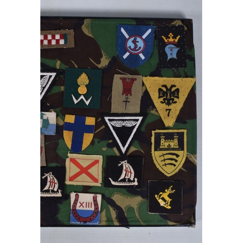 266 - RIKER FRAME CONTAINING AN ACCUMULATION OF BRITISH ARMY SHOULDER FORMATION PATCHES WW2 PERIOD, to inc... 