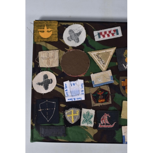 266 - RIKER FRAME CONTAINING AN ACCUMULATION OF BRITISH ARMY SHOULDER FORMATION PATCHES WW2 PERIOD, to inc... 