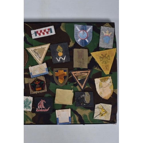 266 - RIKER FRAME CONTAINING AN ACCUMULATION OF BRITISH ARMY SHOULDER FORMATION PATCHES WW2 PERIOD, to inc... 