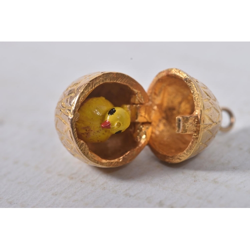 299 - A 9CT GOLD EGG AND CHICK CHARM, yellow gold egg with hinged fittings opening up to reveal an enamel ... 