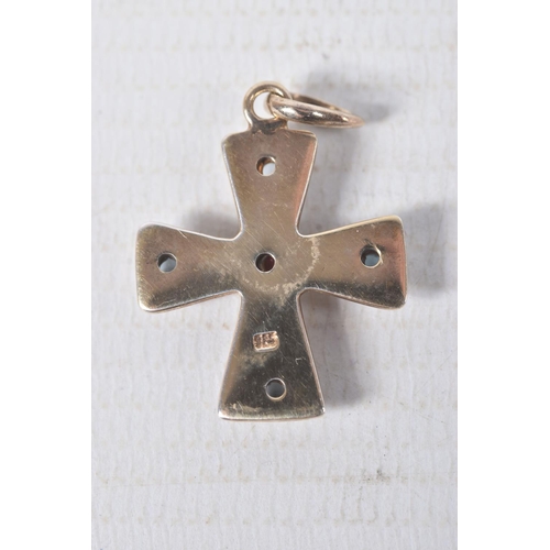 312 - A YELLOW METAL GEM SET CROSS PENDANT, polished cross set with a central garnet cabochon and four top... 