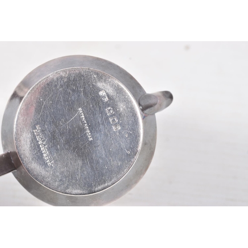 323 - A 'GARRARD & CO' SILVER TEA STRAINER, fitted with a wooden handle, hallmarked 'Garrard & Co Ltd' Lon... 