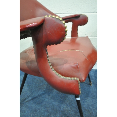 151 - A HARLEQUIN SET OF FOUR RED LEATHERETTE ARMCHAIRS, with a curved backrest, open armrests with brass ... 