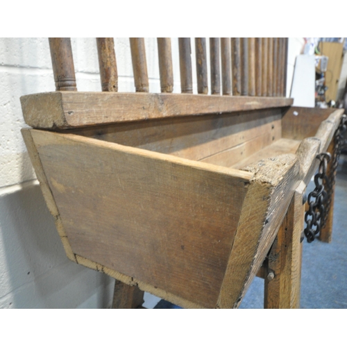 152 - A CATTLE TROUGH, with various alterations and timbers, later legs, with a cattle guard, length 202cm... 