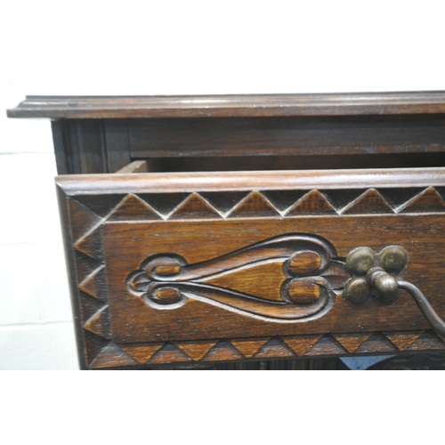 155 - AN EARLY 20TH CENTURY OAK BUFFET, fitted with two drawers, over double cupboard doors, raised on tur... 