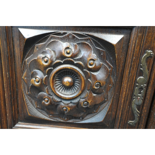 155 - AN EARLY 20TH CENTURY OAK BUFFET, fitted with two drawers, over double cupboard doors, raised on tur... 