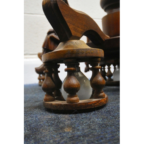 158 - A 20TH CENTURY OAK CEILING LIGHT, with four seated figures, foliate designs, and turned spindles, di... 