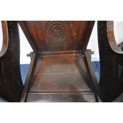 162 - A PAIR OF 20TH CENTURY OAK GLASTONBURY CHAIRS, with various carved details all over, shaped open arm... 