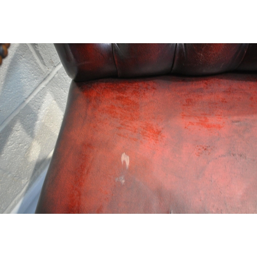 163 - A RED LEATHER BUTTON BACK GAINSBOROUGH CHAIR, with open armrests, width 55cm x depth 65cm x height 9... 