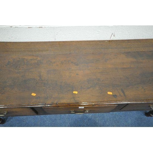 167 - A GEORGIAN AND LATER OAK DRESSER BASE, fitted with three drawers, raised on turned front legs, lengt... 