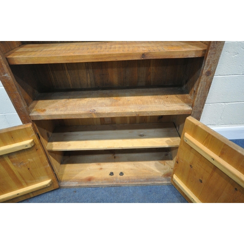 186 - A HARDWOOD OPEN BOOKCASE, fitted with double cupboard doors, condition report: shelf pins previously... 