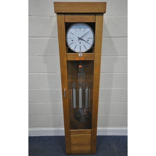 188 - A MODERN OAK CASED CHIMING LONGCASE CLOCK, the glass door enclosing a 10.5 inch dial, depicting Roma... 