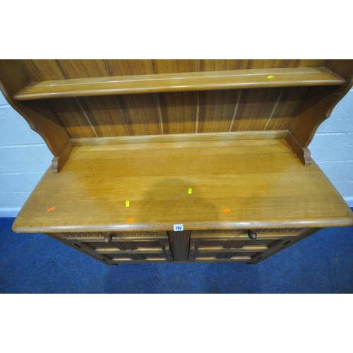 192 - A LATE 20TH CENTURY OAK DRESSER, the two tier plate rack, atop a base with two drawers, over double ... 