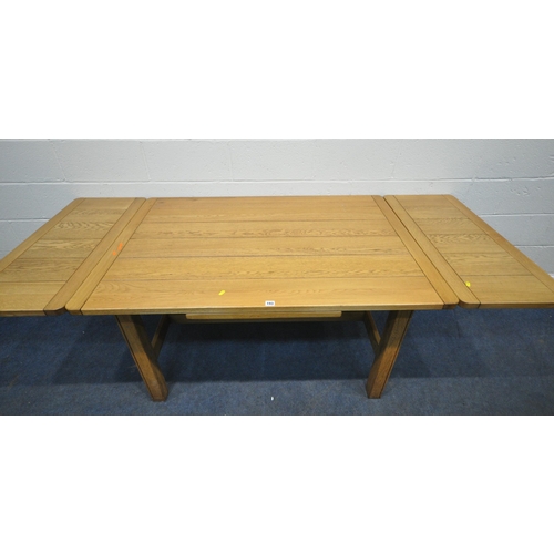 193 - A MODERN OAK DRAWER LEAF EXTENDING DINING TABLE, raised on square legs, united by stretchers, extend... 