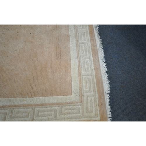 229 - A SALMON PINK GROUND RECTANGULAR RUG, with spiral design border, 241cm x 171cm, condition report: in... 