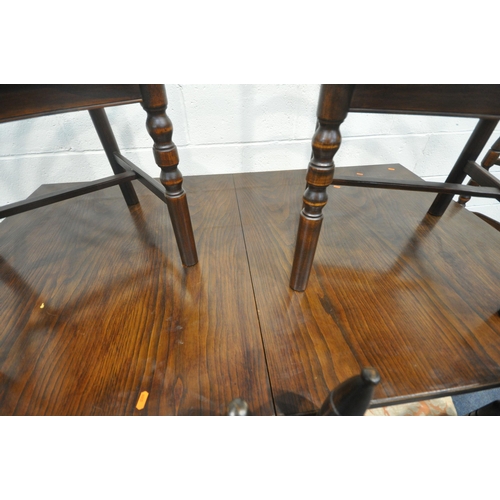 233 - A LATE 20TH CENTURY OAK EXTENDING DINING TABLE, with a single fold out leaf, raised on shaped trestl... 