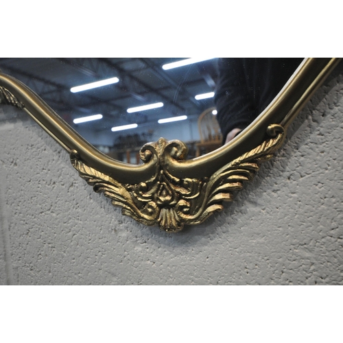 243 - A GOLD PAINTED METAL FRAME WALL MIRROR, with scrolled and foliate details, 80cm x 85cm, condition re... 