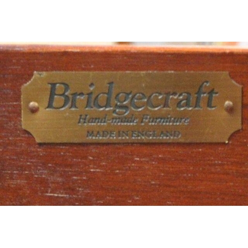 249 - A BRIDGECRAFT MAHOGANY DROP LEAF SOFA TABLE, with two frieze drawers, raised on shaped legs, with br... 