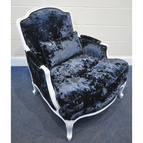 265 - A LARGE WHITE PAINTED ARMCHAIR, with a deep seat, dark blue upholstery, raised on cabriole legs, wid... 