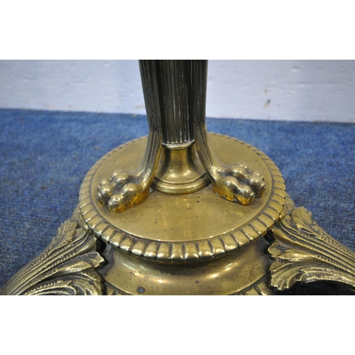 267 - A 20TH CENTURY BRASS STANDARD LAMP, with a foliate pillar, triple rams head, three scrolled supports... 