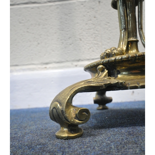 267 - A 20TH CENTURY BRASS STANDARD LAMP, with a foliate pillar, triple rams head, three scrolled supports... 